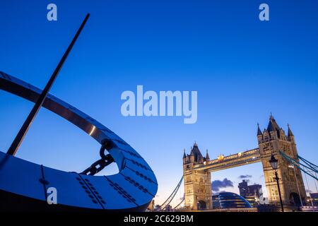 Uhr Skulptur und Tower Bridge bei der Abenddämmerung, London, England Stockfoto