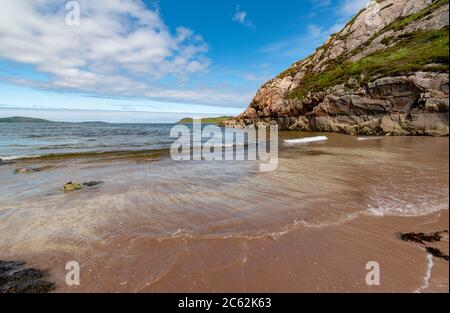GRUINARD BAY UND STRAND ROSS UND CROMARTY WESTKÜSTE SCHOTTLAND FRÜHSOMMER KLEINE BUCHT MIT WELLEN ÜBER WEISSEM UND ROTEM SAND Stockfoto
