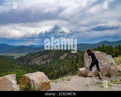 Frau mit Blick über den Rand der Klippe, Monarch Colorado, USA Stockfoto