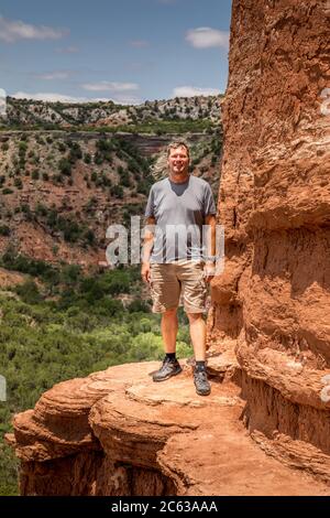 Mann, der am Rande des Lighthouse Rock steht, Palo Duro Canyin State Park, Texas Stockfoto