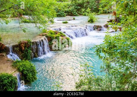 Unterhalb der Mooney Falls auf Havasu Creek gibt es viele Pools und Wasserfälle, die von üppiger grüner Vegetation umgeben sind. Auf Havasupai Indian Tribe Land, AZ. Stockfoto