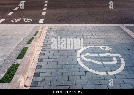 Neue Fahrradwege neben Ladestationen für Elektrofahrzeuge auf Asphalt. Stockfoto