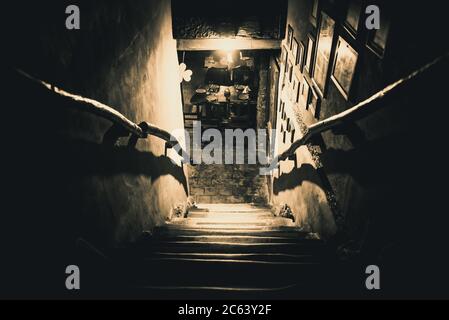 Dramatische Sicht auf die unheimlich Treppen von oben in die Dunkelheit des Inneren des alten Pubs Stockfoto