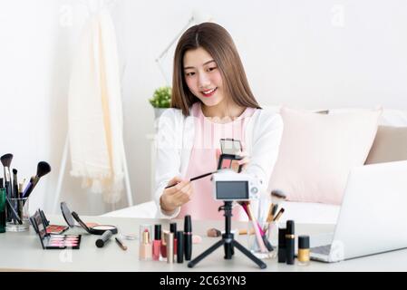 Schöne asiatische Schönheit vlogger tun Produktbewertung Live-Übertragung vor der Kamera zu Hause Stockfoto