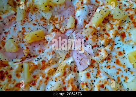 Blick von oben auf frische heiße Pizza mit Ananas und Schinken Stockfoto
