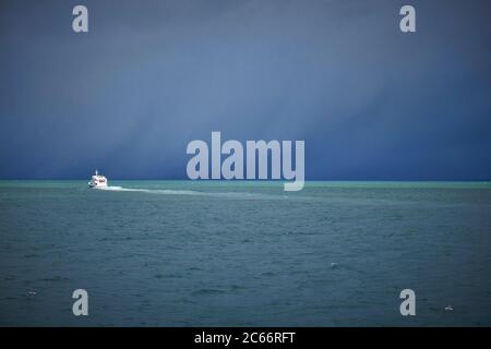 Island, Hafen Reykjavik, Bootstour, Walbeobachtung, Boot in der Ferne, Regenwolken Stockfoto