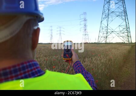 Ingenieur in einem Helm mit einem Meter. Energieerzeugung und Energiewirtschaft. Stockfoto