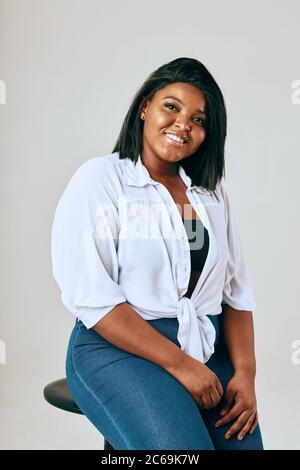 Glücklich african übergewichtete Frau posiert isoliert über weißen Studio Hintergrund. Körper Positiv. Stockfoto