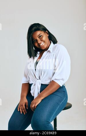 Glücklich african übergewichtete Frau posiert isoliert über weißen Studio Hintergrund. Körper Positiv. Stockfoto