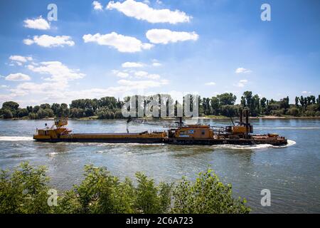 Ein Schiff mit einem hydraulischen Ponton auf Stelzen mit einem Kabelbagger der Wasserbaugesellschaft OHF Wasserbau am Rhein, Köln Stockfoto
