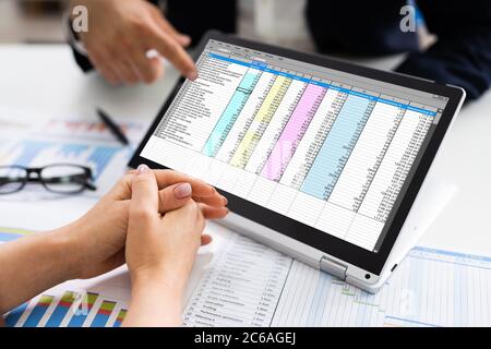 Analyst Mitarbeiter Arbeitet An Tabelle Mit Laptop Stockfoto