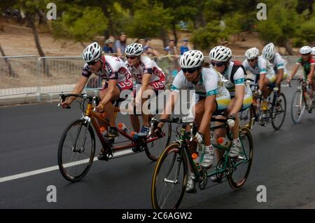 Athen, Griechenland 25SEP04: Straßenradsport bei den Paralympischen Spielen: Frauen-Straßenrennen für blinde Radsportarten, USA, links und Australien, rechts. USA Katie Compton (vorne) und Karissa Whitsell (hinten, blind), gegen Lindy Hou (vorne) und Toireasa Ryan (hinten, blind). ©Bob Daemmrich Stockfoto