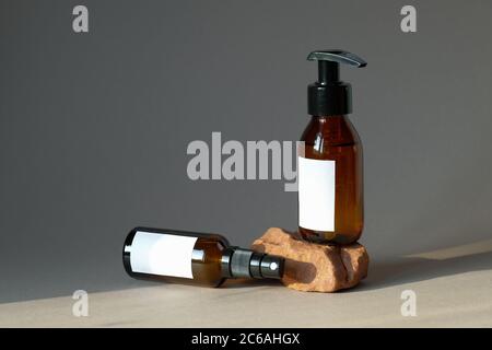 Set von kosmetischen dunkel Bernstein Glasflaschen mockup. Pumpe Flasche Handseife und organische Körperspray. Natürliche SPA Kosmetik Verpackung Design. Stockfoto