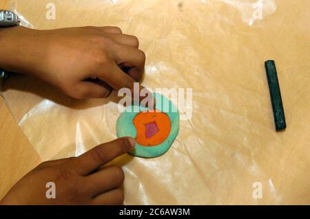 Austin Texas, USA, 2005: Junger Student formt ein Handwerksprojekt aus Lehm während des Kunstunterrichts nach der Schule. Stockfoto