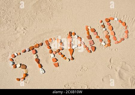 Das Wort ‘SStrand aus Felsen am Strand Stockfoto