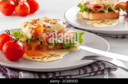 Eier Benedikt auf getoasteten Muffins mit Schinken und Sauce Stockfoto