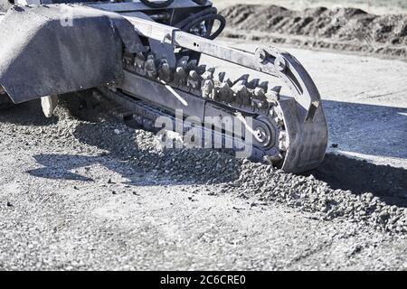 Nahaufnahme einer Grabenkette in Bewegung Vorbereitung auf einen Graben in Schmutz zu graben Stockfoto