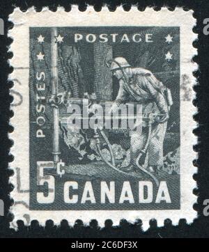 KANADA - UM 1957: Stempel gedruckt von Kanada, zeigt Bergmann mit pneumatischem Bohrer, um 1957 Stockfoto