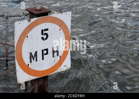 Dock-Schild mit einer Boot-Geschwindigkeitsbegrenzung von fünf Meilen pro Stunde mit einem Vogel auf der Spitze, im East River oder Harlem River Stockfoto