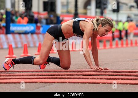 Die britische Eliteläuferin Hayley Carruthers krabbelt beim Virgin Money London Marathon 2019, England, Großbritannien, über die Ziellinie Stockfoto