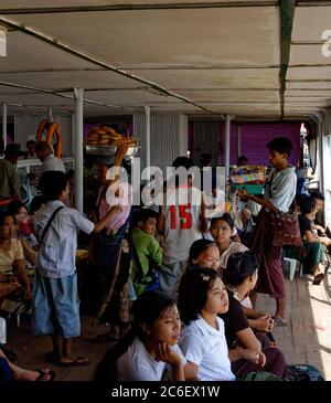 Falkiers verkaufen an Passagiere, die auf der Yangon-Dala-Fähre in Myanmar sitzen Stockfoto