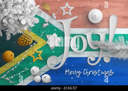 Südafrika Flagge auf Holztisch mit Joy Text. Weihnachten und Neujahr Hintergrund, Feier nationalen Konzept mit weißem Dekor. Stockfoto