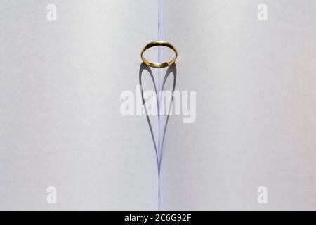 Ring in der Falte eines Buches, herzförmigen Schatten Stockfoto