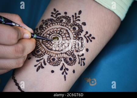 Mehndi Künstler machen Mehndi Design auf der indischen Brauthand. Mehndi ist traditionelle indische dekorative Kunst Stockfoto