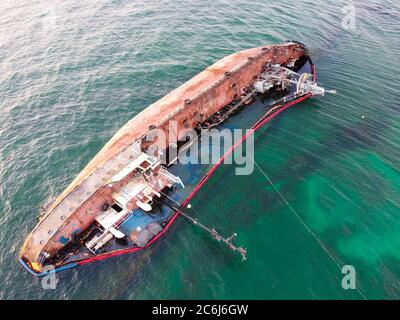 Ein Tanker, der an der Küste versank, eine Umweltkatastrophe, Verschmutzung von Brennstoff und Ölprodukten der Küste auf See. Stockfoto