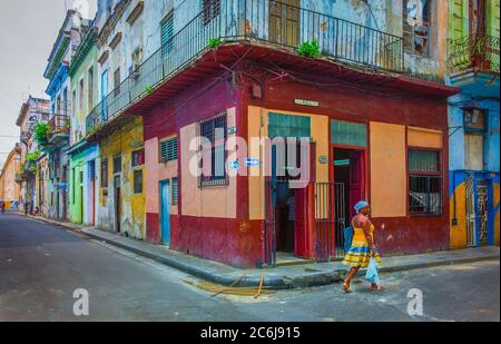 Havanna, Kuba, Juli 2019, Frau, die an einem Lebensmittelgeschäft an der Ecke Calle Muralla & Cuba im ältesten Teil der Stadt vorbei geht Stockfoto