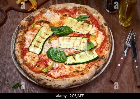 Italienische Vegan Pizza Zucchini auf dunklem Holztisch. Gesunde Ernährung Stockfoto