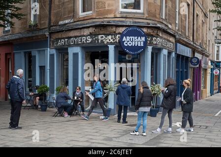 Kunden stehen vor einem Café am Leith Walk in Edinburgh an, da die Beschränkungen in Schottland während der Pandemie von Covid-19 allmählich gelockert werden. Stockfoto