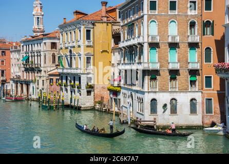 Venedig, Italien - 20. April 2019: Venezianischer Kanal mit Gondeln und historischen Häusern, an einem schönen sonnigen Tag. Stockfoto