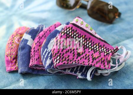 DIY handgemachte Handwerk Schutzmaske aus Baumwollstoff mit bunten Farben. Konzept zum Schutz vor COVID-19, Coronavirus und Staubbelastung. Stockfoto