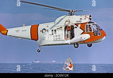 Astronauten James A. McDivitt, Kommandant der Apollo 9 prime Crew, ist bis zu einem U.S. Coast Guard Hubschrauber in einer neuen Art rescue Net während Wasser egress Ausbildung in den Golf von Mexiko hochgezogen. Stockfoto