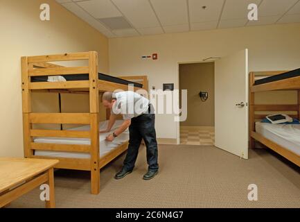 Techniker Jonathan Bankston streightens bis ein Stockbett in einem von mehreren Schlafräumen an der Catlett Freiwillige Feuerwehr - Retten, Station 7, in Catlett, VA am Mittwoch, 4. Mai 2011. Stockfoto