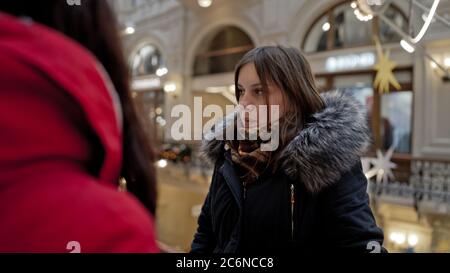 Das Treffen der Freundinnen. Zwei Frauen diskutieren in einem Einkaufszentrum über etwas. Stockfoto