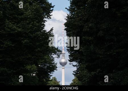 Berlin, Deutschland. Juli 2020. Der Fernsehturm ist zwischen zwei Laubbäumen zu sehen. Quelle: Jörg Carstensen/dpa/Alamy Live News Stockfoto