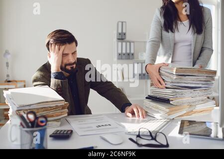 Arbeiter Unternehmer müde empört unglücklich sitzen am Arbeitsplatz Arbeit im Büro. Stockfoto