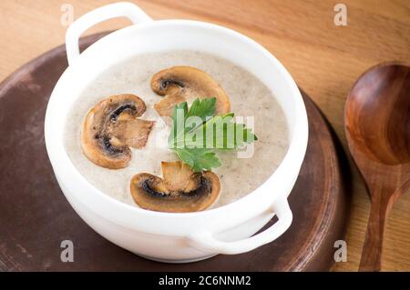 Pilzsuppe püriert. Serviert werden Gerichte. Suppe auf einem weißen Teller. Stockfoto