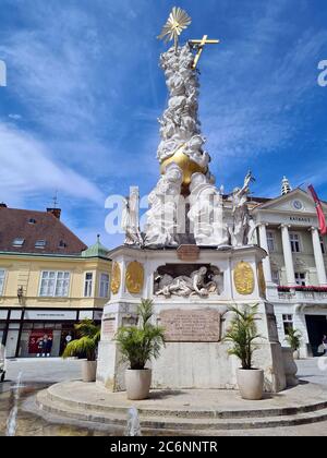 Baden, Österreich - 08. Juli 2020: Hauptplatz mit Pestsäule und Trinitätssäule und Rathaus in der Fußgängerzone der Kurstadt Niederösterreich Stockfoto