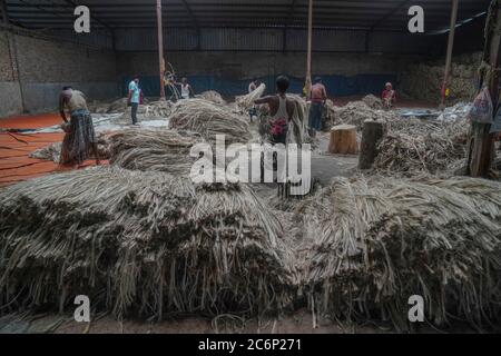 Narayanganj, Bangladesch. Juli 2020. Menschen, die in einer Jute-Verarbeitungsfabrik in Narayanganj bei Dhaka, Bangladesch, arbeiten.Jute, auch bekannt als die goldene Faser von Bangladesch, spielt eine wichtige Rolle in der nationalen Wirtschaft. Achtzig Prozent der weltweit hochwertigen Jute wächst in Bangladesch. Jute wird bei der Herstellung von Tuch, Schal, Seilen, Teppich-Trägertuch, Büchsenbeutel und viele andere nützliche Dinge verwendet. Jute-Beutel sind sehr gut geeignet für das Verpacken von Lebensmittelkörnern. Kredit: SOPA Images Limited/Alamy Live Nachrichten Stockfoto