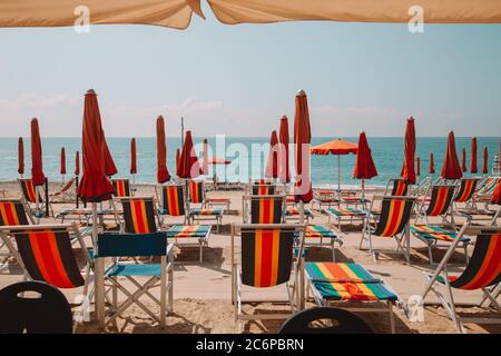 Strand mit Sonnenliegen und Sonnenschirmen ausgestattet Stockfoto