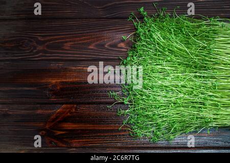 Kleeblatt Sprossen auf Holztisch Hintergrund Draufsicht. Gekeimt Gemüsesamen für rohe Ernährung Lebensmittel, Micro Green gesunde Ernährung Konzept. Stockfoto