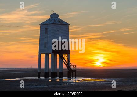 Burnham-on-Sea, Somerset, Großbritannien. Juli 2020. Wetter in Großbritannien. Ein dramatischer goldener Sonnenuntergang am historischen Leuchtturm Low, der vom Strand von Burnham-on-Sea in Somerset am Ende eines heißen, sonnigen Tages betrachtet wird. Der neunbeinige Leuchtturm aus Holz wurde 1832 erbaut und ist unter Denkmalschutz der Stufe II. Bildquelle: Graham Hunt/Alamy Live News Stockfoto