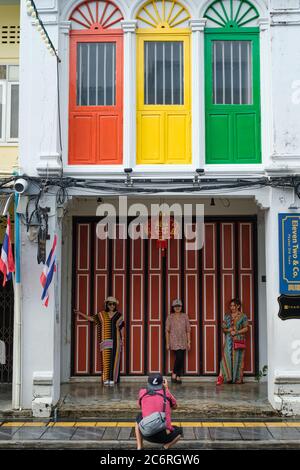 Thailändische Touristen fotografieren vor einem farbenfrohen chinesisch-portugiesischen oder peranakan-artigen Haus in Thalang Rd., Altstadt, Phuket Town, Thailand Stockfoto