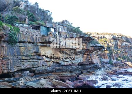 Historische alte Hütten auf einer isolierten Bucht im Buschland des Nationalparks von Sydney, Australien Stockfoto