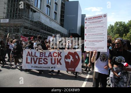 Demonstranten halten während der Demonstration ein BLM-Banner auf der Straße.All Black Lives Matter Demonstranten marschierten vom Hyde Park zum Parliament Square. Die von der Jugend geführte Bewegung organisiert jeden Sonntag Proteste, um für Rassengleichheit und Gerechtigkeit für alle Schwarzen in Großbritannien zu kämpfen. Stockfoto