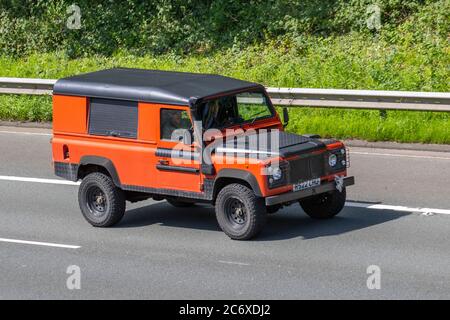 1997 90s, Neunziger, orange schwarz Land Rover 110 Defender TDI; Fahrzeuge für den Fahrzeugverkehr, Fahrzeuge, die Fahrzeuge auf britischen Straßen fahren, Motoren, Autobahnnetz M6. Stockfoto