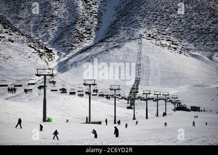 Touristen und Sportler erkunden die Pisten des Skistützpunktes Chunkurchak im Gebiet Chuy in Kirgisistan bei Bischkek. Stockfoto